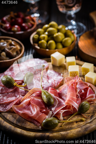 Image of Serrano ham platter with variation of appetizers