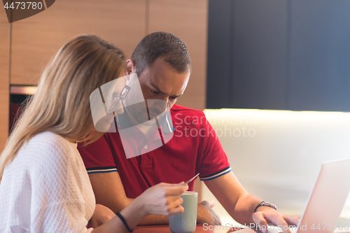 Image of happy young couple buying online