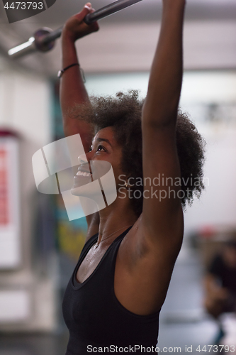 Image of black woman lifting empty bar