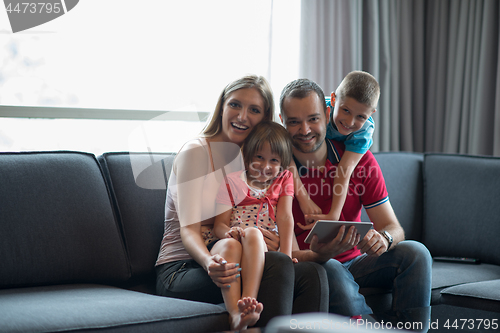 Image of happy young couple spending time with kids