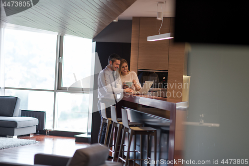 Image of A young couple is preparing for a job and using a laptop