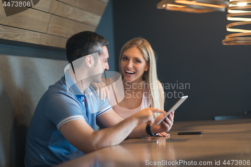 Image of couple using tablet at home