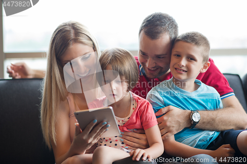 Image of happy young couple spending time with kids