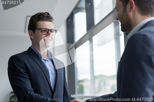 Image of cloasing the deal in modern office interior