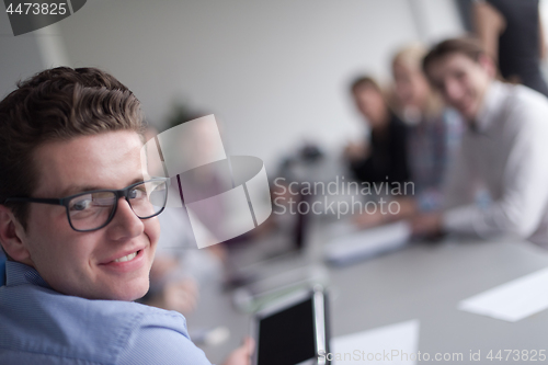 Image of Businessman using tablet in modern office