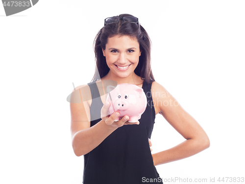 Image of Young woman with glasses happy with piggy bank