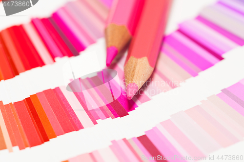 Image of red and pink colored pencils and color chart of all colors