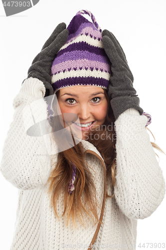 Image of Face of pretty woman with gloves and knitted winter cap  with smile