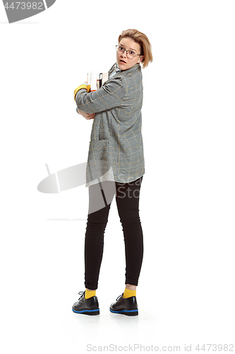 Image of Full length portrait of a sad female student holding books isolated on white background