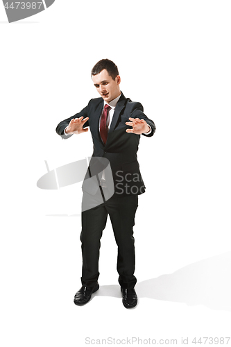 Image of Above front portrait of a businessman with very serious face. Confident professional with piercing look in the foreground of the camera.