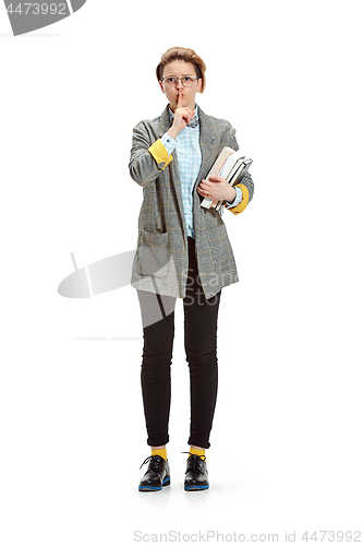 Image of Full length portrait of a sad female student holding books isolated on white background