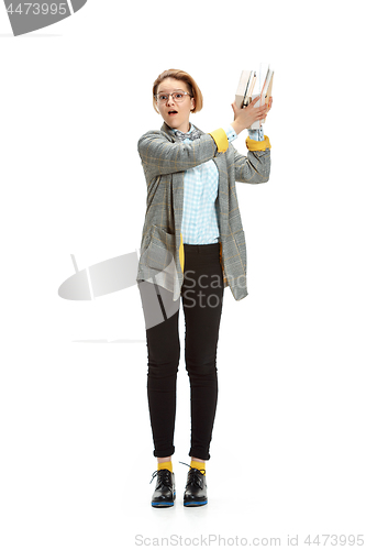 Image of Full length portrait of a surprised female student holding books isolated on white background