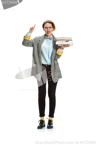 Image of Full length portrait of a happy smiling female student holding books isolated on white background