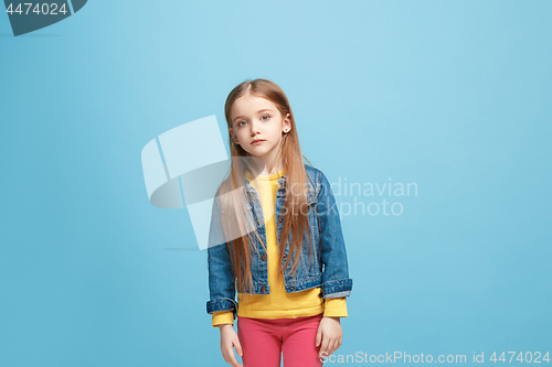 Image of Beautiful teen girl looking suprised and bewildered isolated on blue