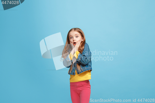 Image of Beautiful teen girl looking suprised isolated on blue