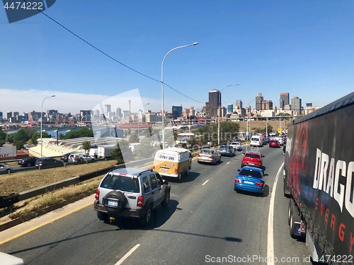 Image of Johannesburg Central Business District buildings and roads as seen from out of a driving car.