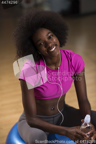 Image of woman  relaxing after pilates workout