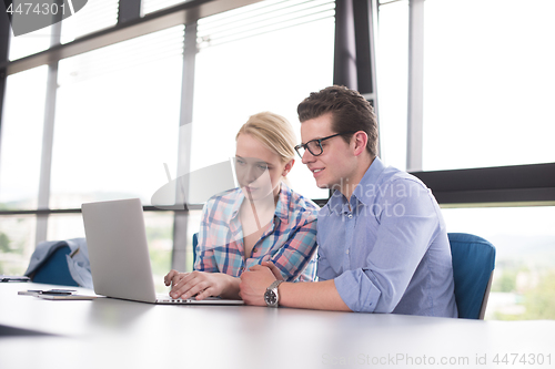 Image of Two Business People Working With laptop in office