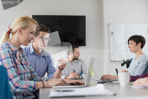 Image of Two Business People Working With laptop in office