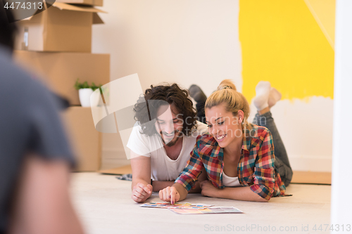 Image of Happy young couple relaxing after painting