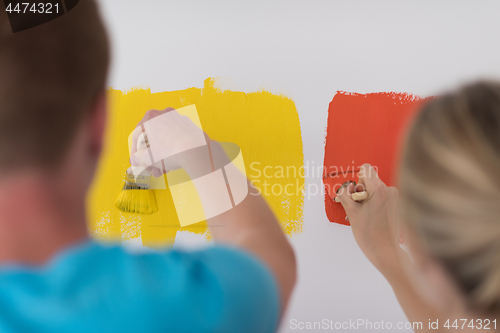 Image of couple painting interior wall