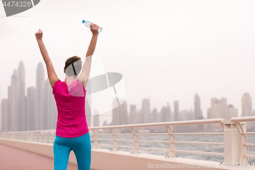 Image of young woman celebrating a successful training run