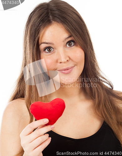 Image of young woman in love with a heart in hand