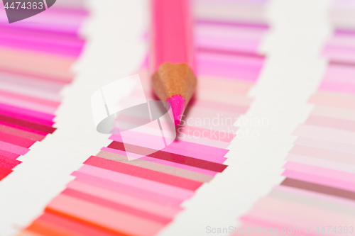Image of red and pink colored pencils and color chart of all colors