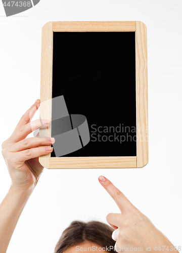 Image of woman\'s hands holding a blackboard publicity