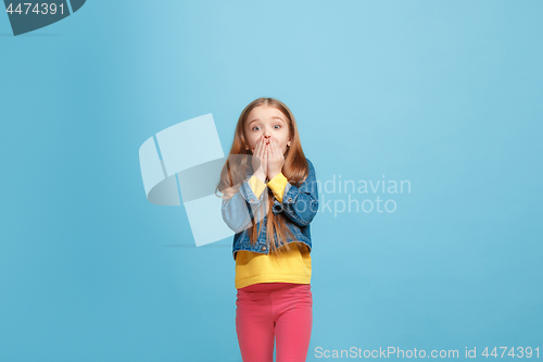 Image of Beautiful teen girl looking suprised isolated on blue