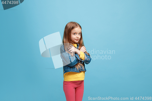 Image of Beautiful teen girl looking suprised and bewildered isolated on blue