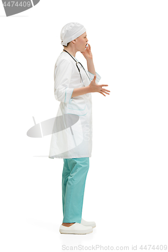 Image of Beautiful young woman in white coat posing at studio. Full length studio shot isolated on white.