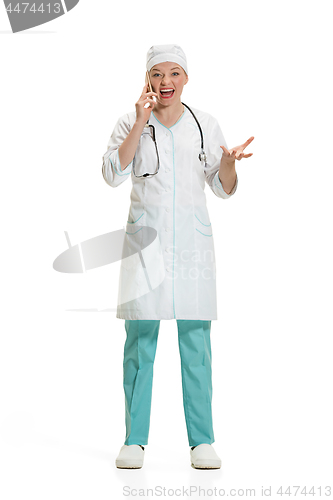 Image of Beautiful young woman in white coat posing at studio. Full length studio shot isolated on white.