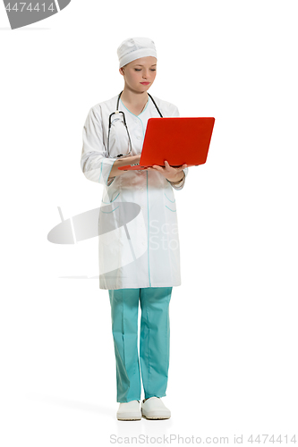 Image of Beautiful young woman in white coat posing at studio. Full length studio shot isolated on white.