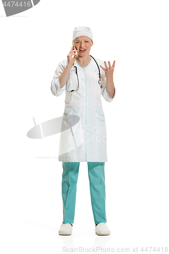 Image of Beautiful young woman in white coat posing at studio. Full length studio shot isolated on white.