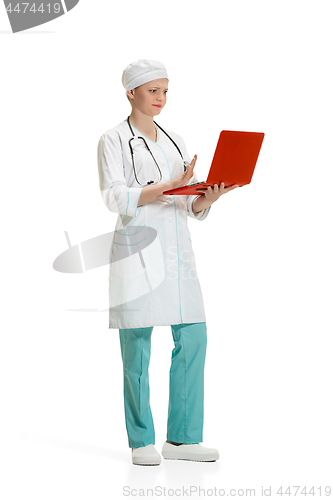 Image of Beautiful young woman in white coat posing at studio. Full length studio shot isolated on white.