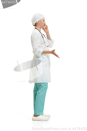 Image of Beautiful young woman in white coat posing at studio. Full length studio shot isolated on white.