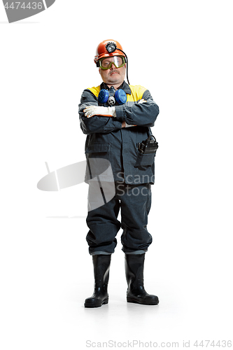 Image of The studio shot of senior bearded male miner standing at the camera on a white background.