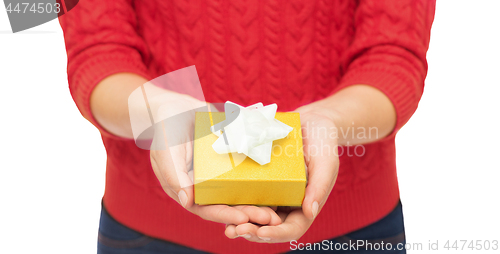 Image of close up of woman in red sweater holding gift box