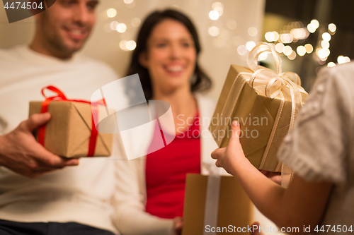 Image of close up of family with christmas gifts at home