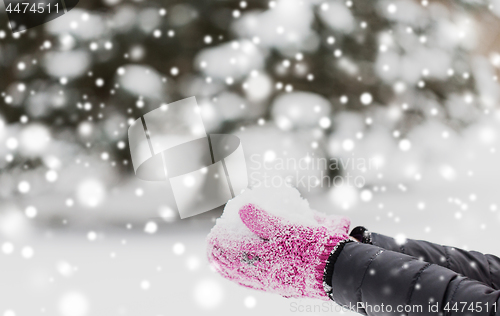 Image of close up of woman holding snow outdoors