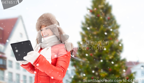 Image of woman with tablet pc over christmas tree