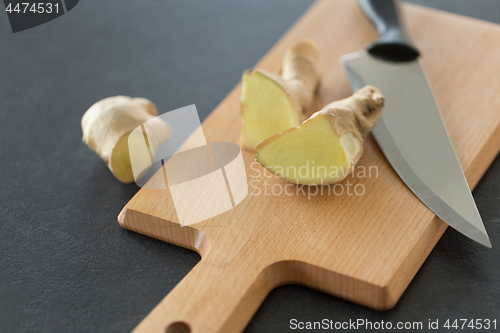 Image of close up of ginger root and knife on cutting board