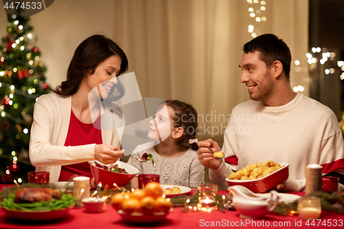 Image of happy family having christmas dinner at home