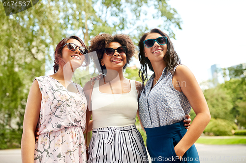 Image of happy young women in sunglasses at summer park