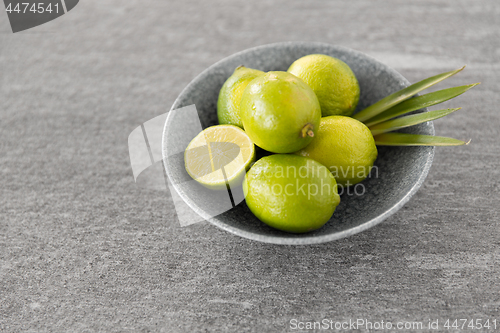 Image of close up of whole limes in bowl