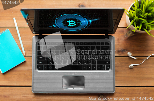 Image of laptop computer with bitcoin symbol on screen