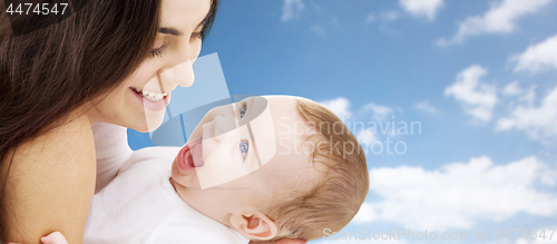 Image of mother with baby over sky background