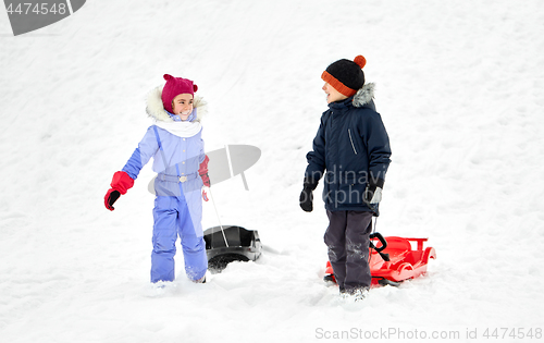 Image of happy little kids with sleds in winter