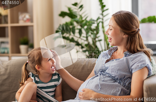 Image of pregnant mother and daughter at home